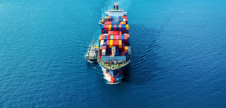 Aerial view of cargo ship with cargo container on sea.